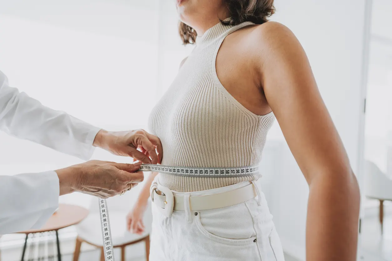 Stubborn fat treatment options at SlimCare Solutions, waist measured at a consultation